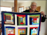 thumbnail Lyn King with one of the quilts-228